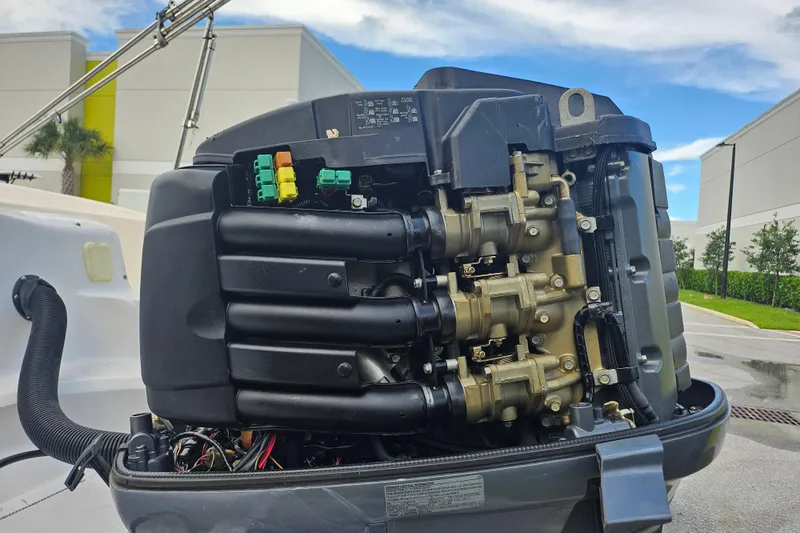 Slide: The Image of 2006 Hurricane SunDeck 237 OB boat engine, detailed view with components exposed. - 5