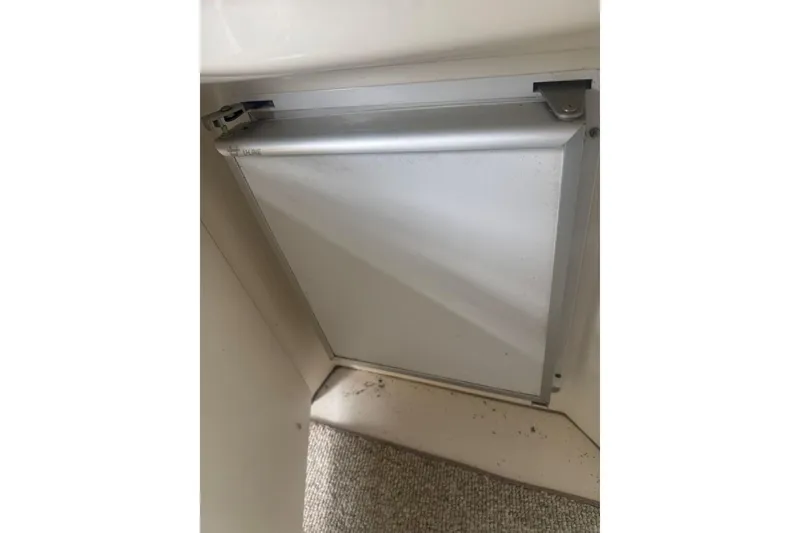 Slide: The Image of Compartment door on a 2005 Sea Ray 340 Sundancer boat interior. - 12