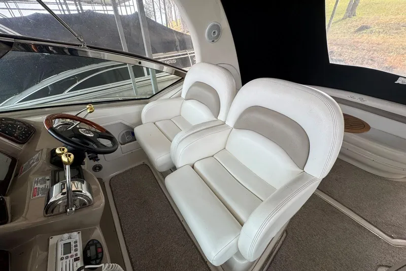 Slide: The Image of 2005 Sea Ray 340 Sundancer cockpit with dual white seats and steering wheel. - 15