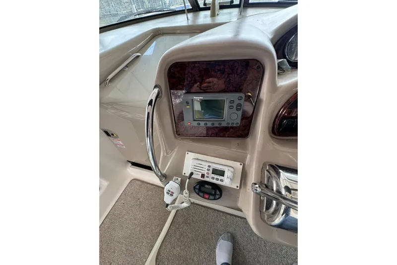 Slide: The Image of 2005 Sea Ray 340 Sundancer helm with navigation controls and steering wheel. - 18