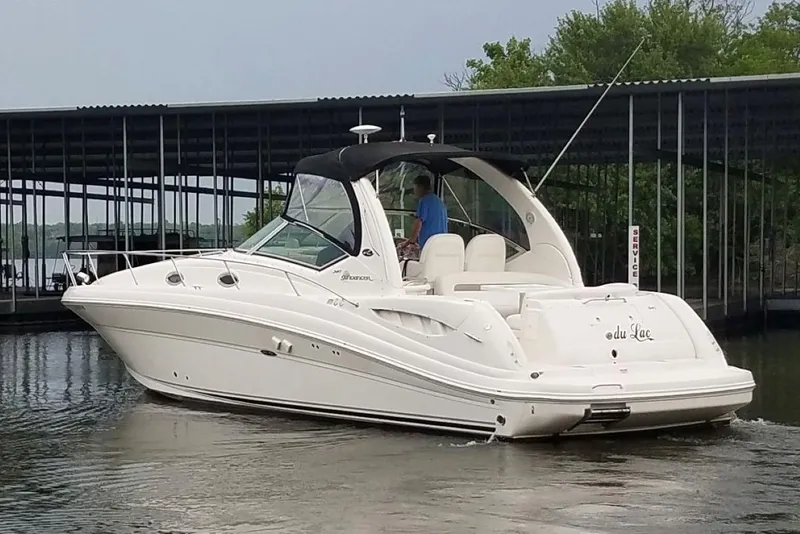 Slide: The Image of 2005 Sea Ray 340 Sundancer boat docked near marina, side view. - 2