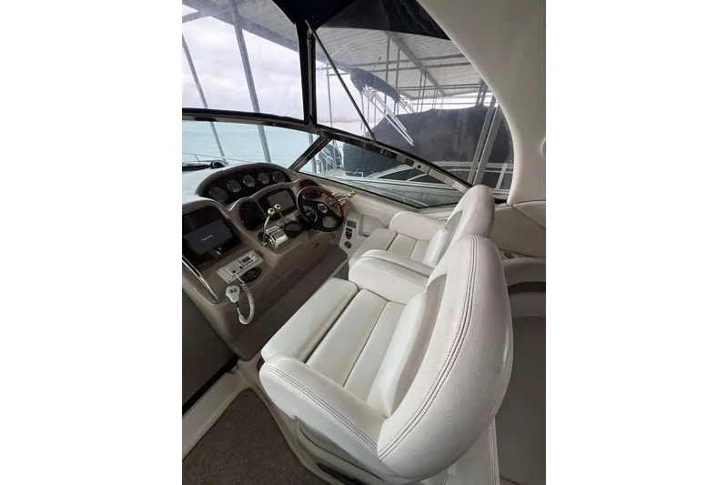 Slide: The Image of 2005 Sea Ray 340 Sundancer helm with white leather seats and control panel. - 20