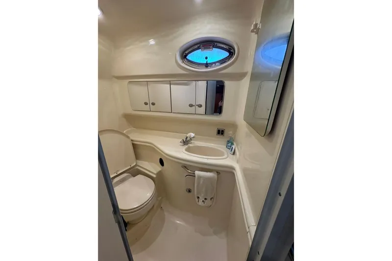 Slide: The Image of Bathroom interior of 2005 Sea Ray 340 Sundancer yacht, featuring sink and toilet. - 31