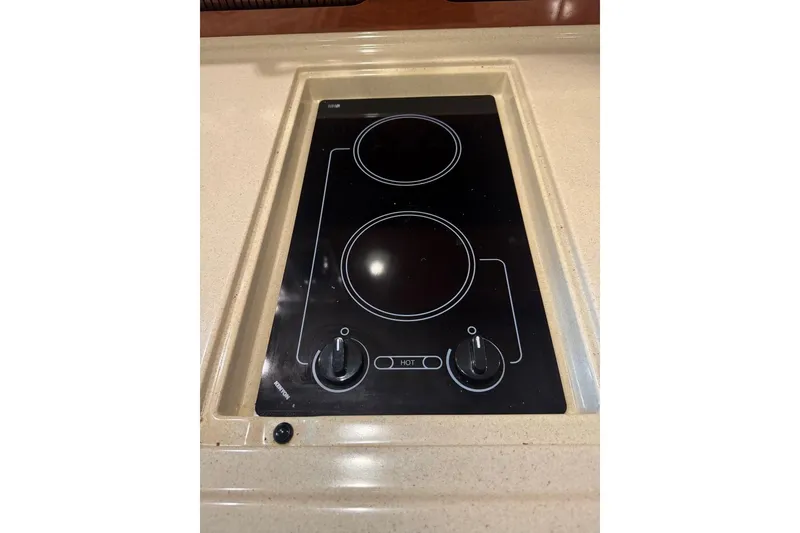 Slide: The Image of 2005 Sea Ray 340 Sundancer stove with two burners on a sleek countertop. - 32