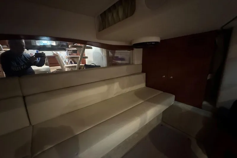 Slide: The Image of Interior of 2005 Sea Ray 340 Sundancer with beige seating and wooden cabinetry. - 35