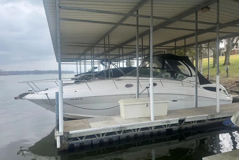 Slide: The Image of 2005 Sea Ray 340 Sundancer docked under covered marina on a cloudy day. - 4