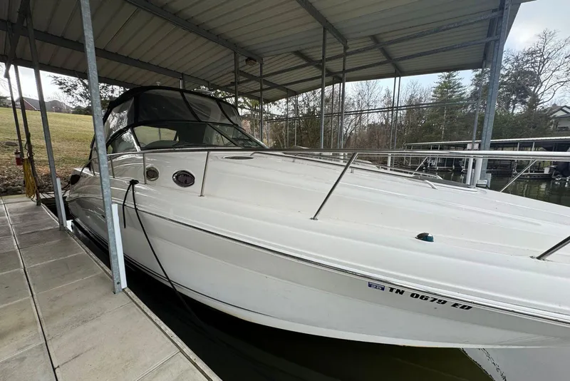Slide: The Image of 2005 Sea Ray 340 Sundancer docked under a covered marina, side view. - 5