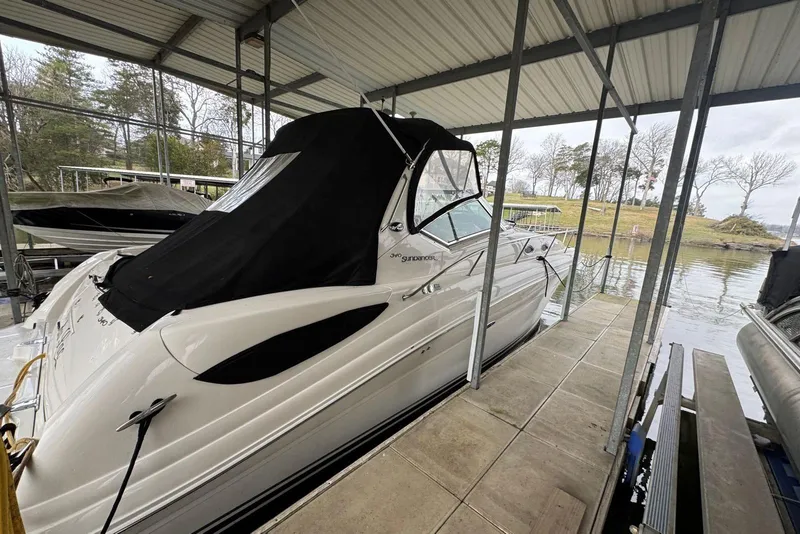 Slide: The Image of 2005 Sea Ray 340 Sundancer docked under a covered marina, side view. - 7