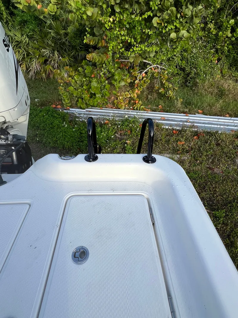 Slide: The Image of Rear view of a 2016 Blue Wave 2400 PureBay boat with engine. - 11