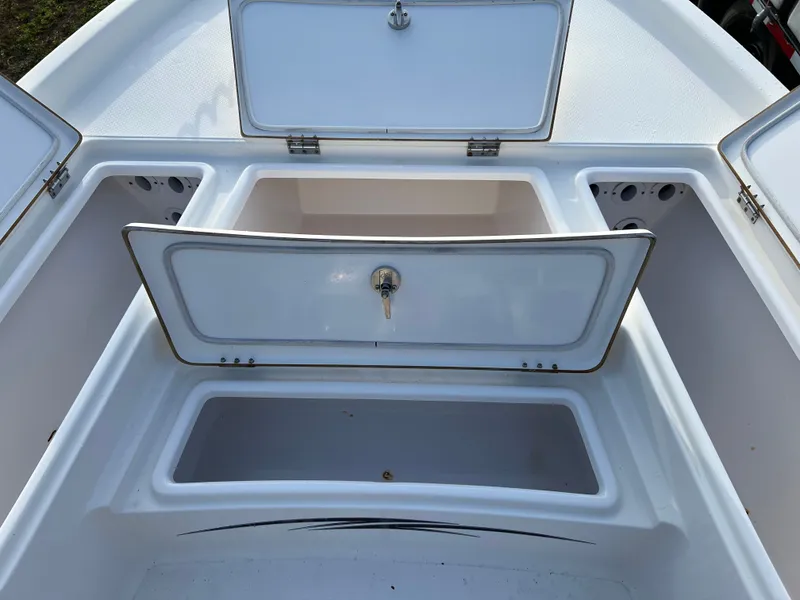 Slide: The Image of 2016 Blue Wave 2400 PureBay boat with open storage compartments. - 48