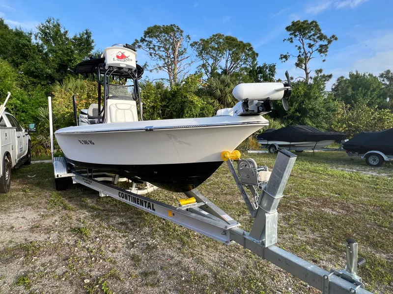 Slide: The Image of 2016 Blue Wave 2400 PureBay boat on trailer outdoors. - 9