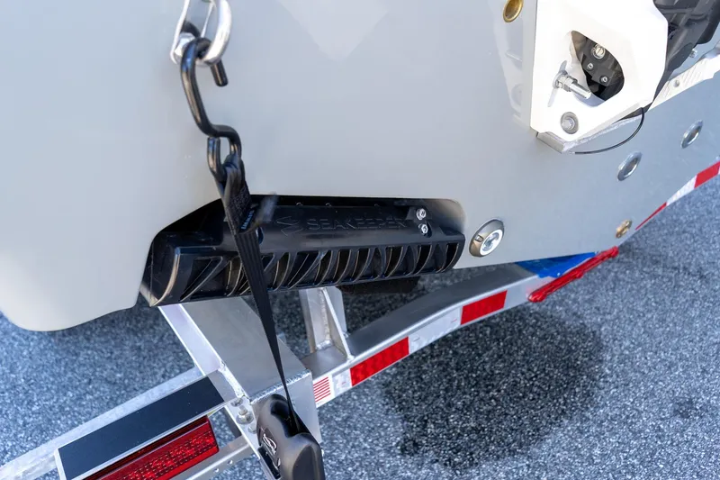 Slide: The Image of 2026 Sportsman Open 252 Center Console boat on trailer, featuring Seakeeper technology. - 11