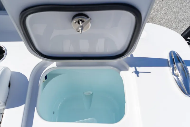 Slide: The Image of 2026 Sportsman Open 252 Center Console livewell with open lid, showcasing interior design. - 17