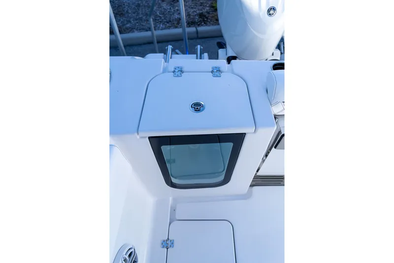 Slide: The Image of 2026 Sportsman Open 252 Center Console boat detail, featuring storage compartment and sleek design. - 18