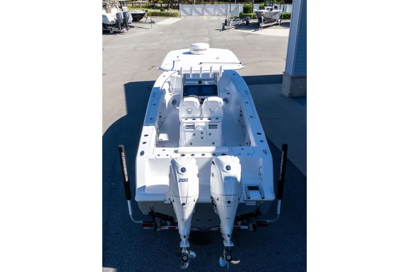 Slide: The Image of 2026 Sportsman Open 252 Center Console boat with dual engines, viewed from above. - 2