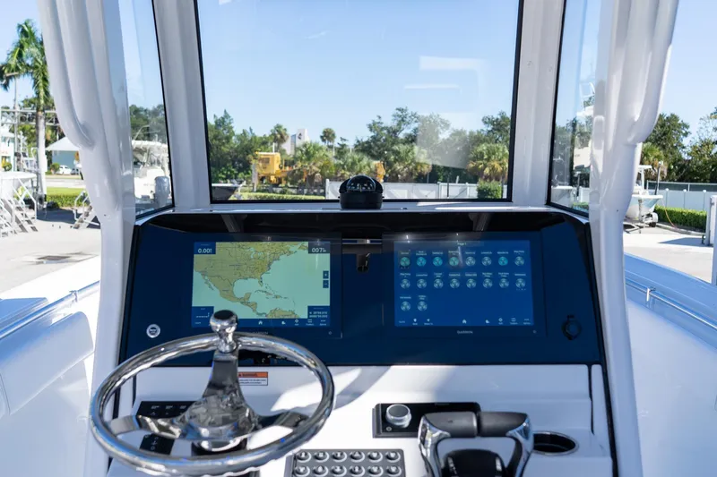 Slide: The Image of 2026 Sportsman Open 252 Center Console dashboard with navigation screens and steering wheel. - 20