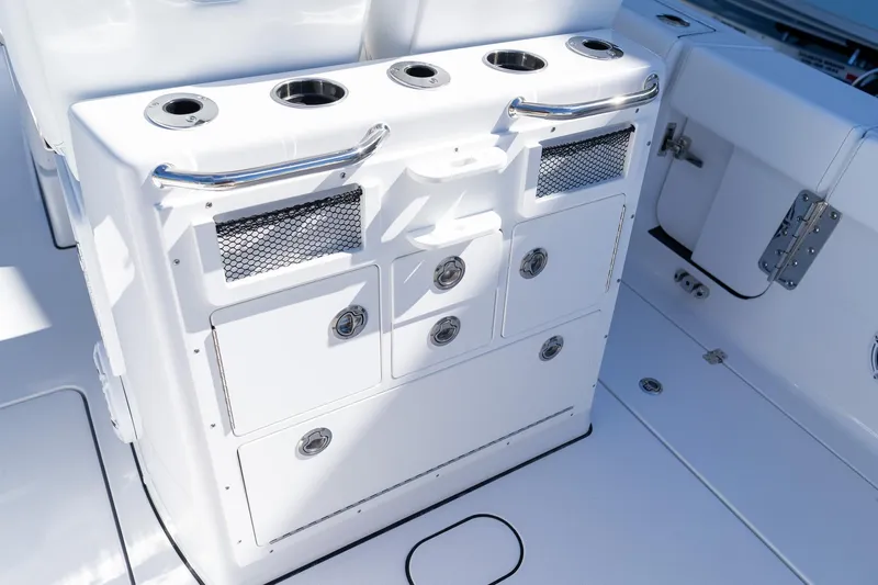 Slide: The Image of 2026 Sportsman Open 252 Center Console boat interior with storage compartments and cup holders. - 22
