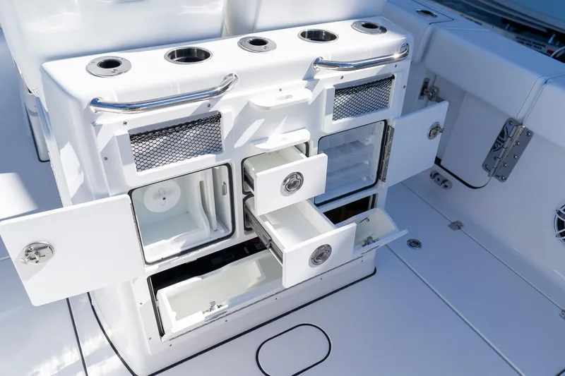 Slide: The Image of 2026 Sportsman Open 252 Center Console boat storage compartments and rod holders. - 23