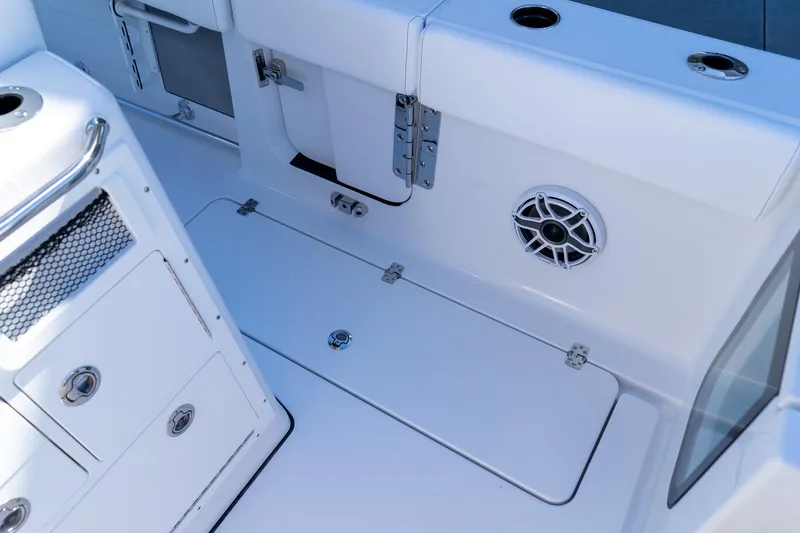 Slide: The Image of 2026 Sportsman Open 252 Center Console boat interior with storage compartments and speaker. - 24