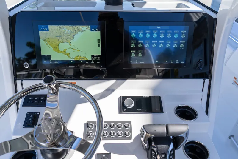 Slide: The Image of 2026 Sportsman Open 252 Center Console dashboard with dual Garmin displays and steering wheel. - 31