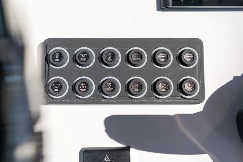 Slide: The Image of Control panel of 2026 Sportsman Open 252 Center Console boat with labeled buttons. - 32