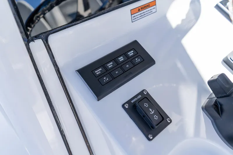Slide: The Image of Control panel of 2026 Sportsman Open 252 Center Console boat, featuring navigation and windlass controls. - 33