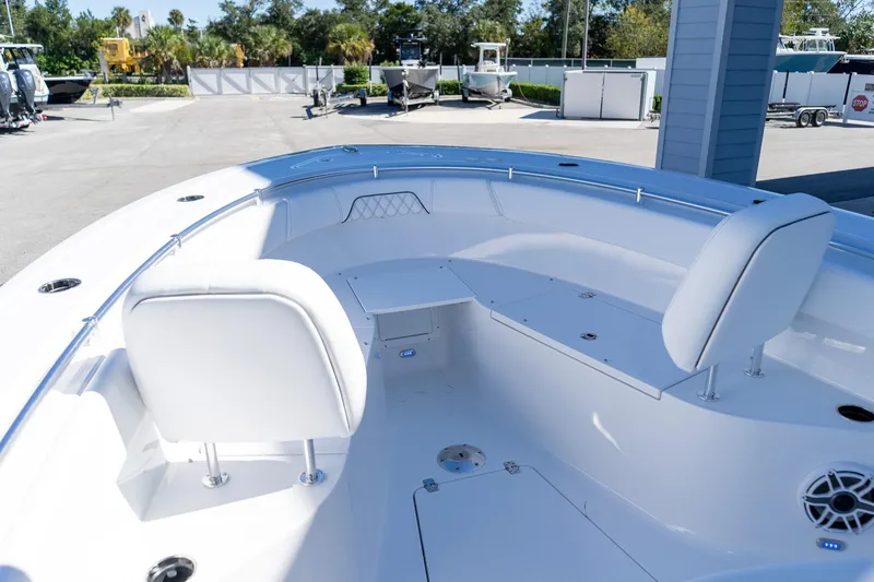 Slide: The Image of 2026 Sportsman Open 252 Center Console boat interior with white seating and storage compartments. - 37