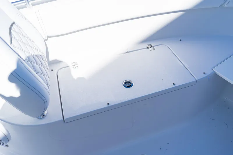 Slide: The Image of 2026 Sportsman Open 252 Center Console interior with white seating and storage compartment. - 41