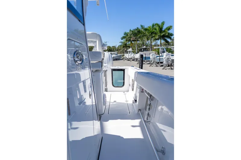 Slide: The Image of 2026 Sportsman Open 252 Center Console boat interior with palm trees in the background. - 45