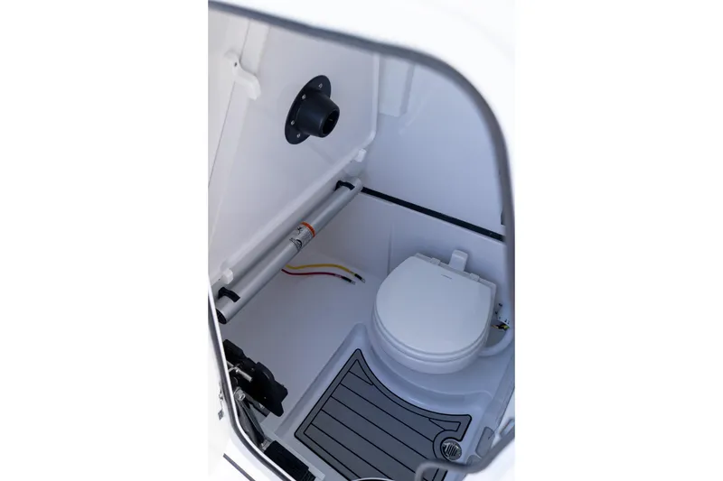 Slide: The Image of 2026 Sportsman Open 252 Center Console boat interior with compact marine toilet. - 51