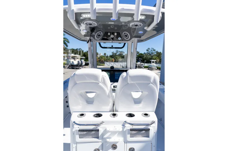 Slide: The Image of 2026 Sportsman Open 252 Center Console interior with dual white seats and overhead speakers. - 55