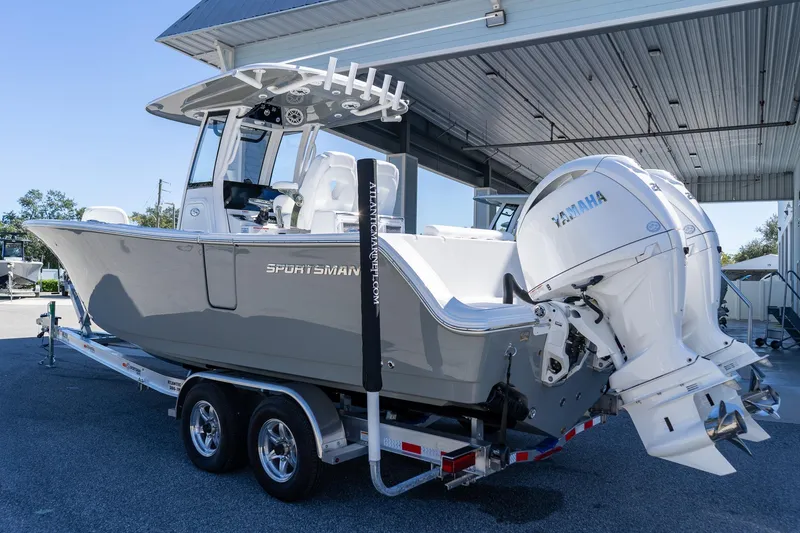 Slide: The Image of 2026 Sportsman Open 252 Center Console boat with dual Yamaha engines on a trailer. - 6