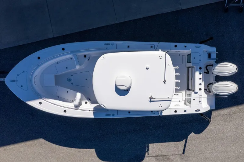 Slide: The Image of 2026 Sportsman Open 252 Center Console boat, aerial view, docked on concrete surface. - 8