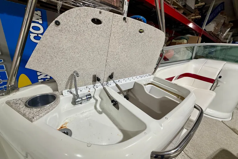 Slide: The Image of 2004 Formula 260 Bowrider boat interior with sink and seating area. - 11