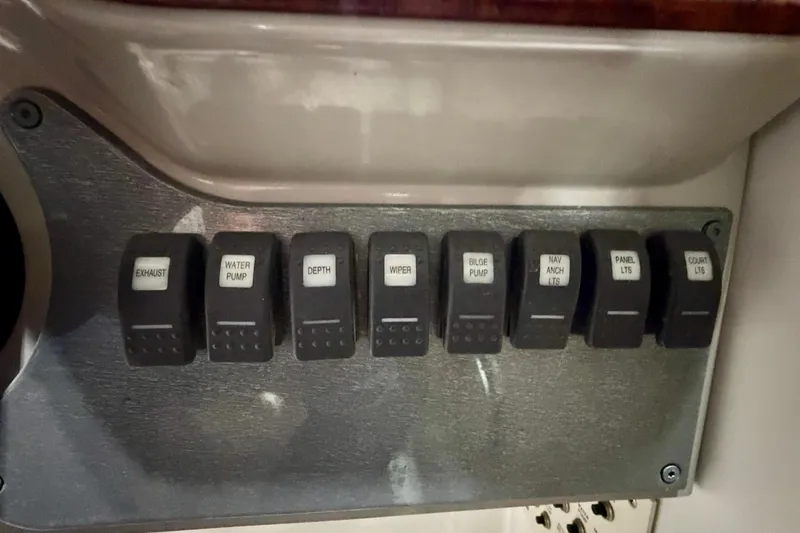 Slide: The Image of Control panel with labeled switches on a 2004 Formula 260 Bowrider boat. - 18