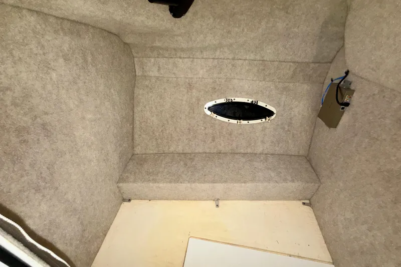 Slide: The Image of 2004 Formula 260 Bowrider interior cabin with oval window and beige upholstery. - 20