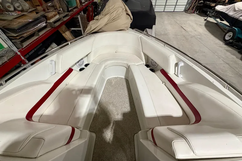 Slide: The Image of 2004 Formula 260 Bowrider interior with white and red seating, stored indoors. - 23