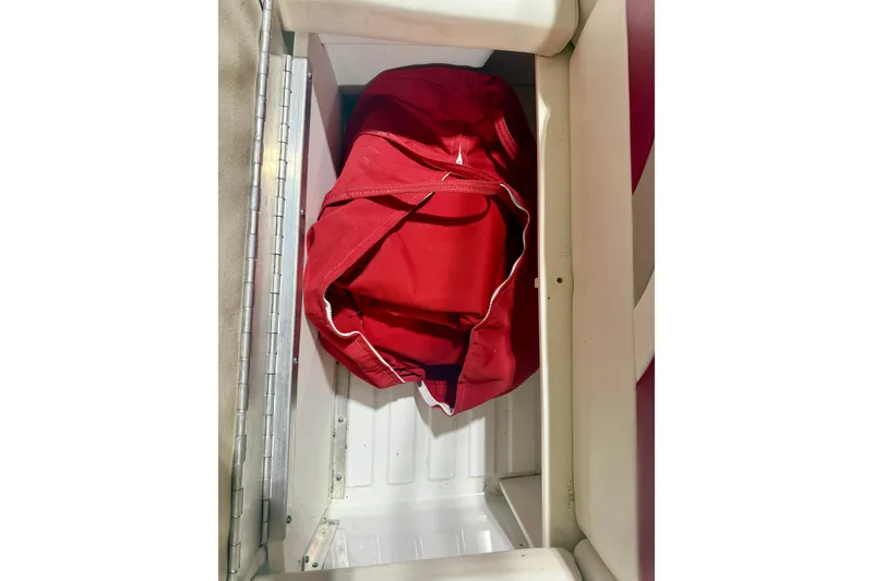 Slide: The Image of Red bag stored in a 2004 Formula 260 Bowrider compartment. - 28