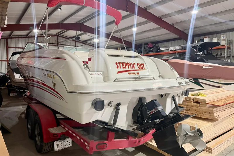 Slide: The Image of 2004 Formula 260 Bowrider boat in storage, featuring red accents and a trailer. - 3