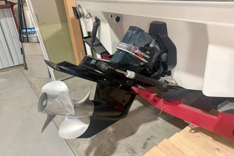 Slide: The Image of 2004 Formula 260 Bowrider boat with Mercury outboard motor in garage. - 4