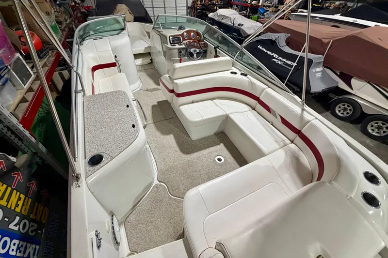 Slide: The Image of 2004 Formula 260 Bowrider boat interior with white and red seating in storage. - 6