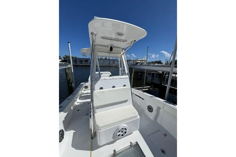 Slide: The Image of 2007 Conch 27 boat with spacious deck and seating, docked under clear blue sky. - 12