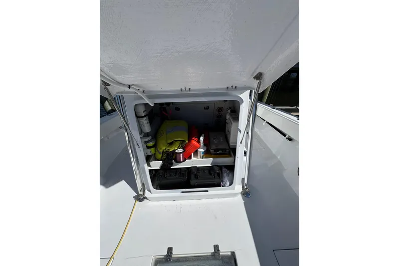 Slide: The Image of 2007 Conch 27 boat with center console and seating, docked under clear blue sky. - 13