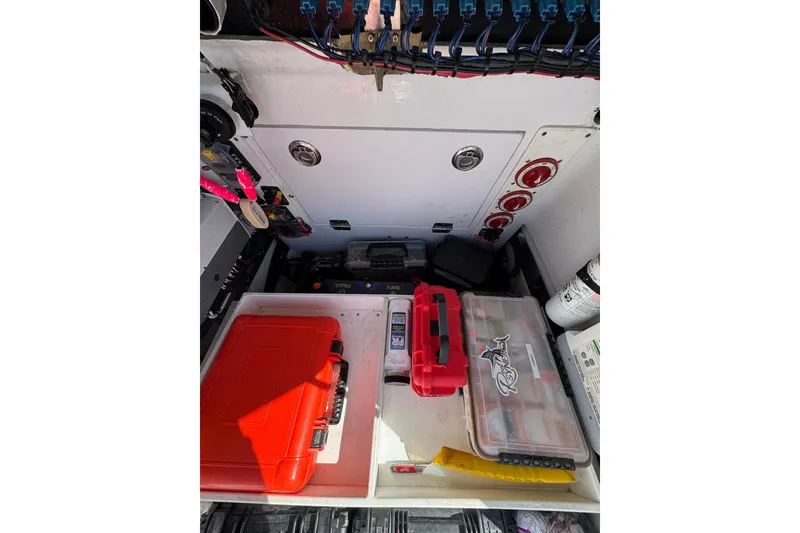 Slide: The Image of 2007 Conch 27 boat storage compartment with tools and equipment neatly organized. - 15