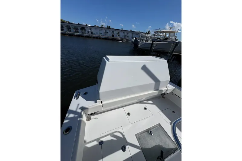 Slide: The Image of 2007 Conch 27 boat interior with seating, docked by waterfront buildings. - 22