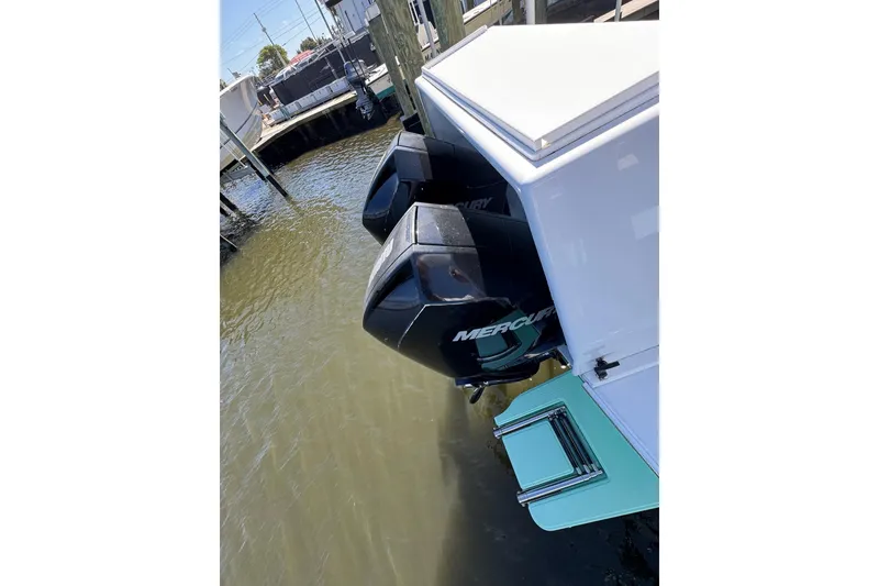 Slide: The Image of 2007 Conch 27 boat deck with storage compartments, docked near waterfront buildings. - 23