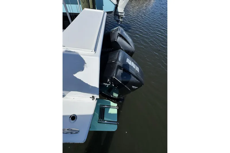 Slide: The Image of 2007 Conch 27 boat with dual Mercury outboard engines docked in marina. - 24