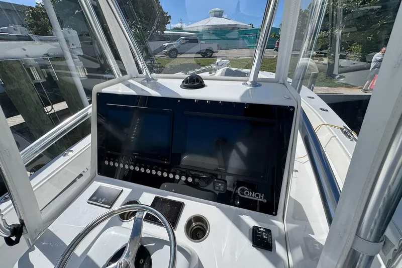 Slide: The Image of 2007 Conch 27 boat cockpit with Garmin navigation system and steering wheel. - 4