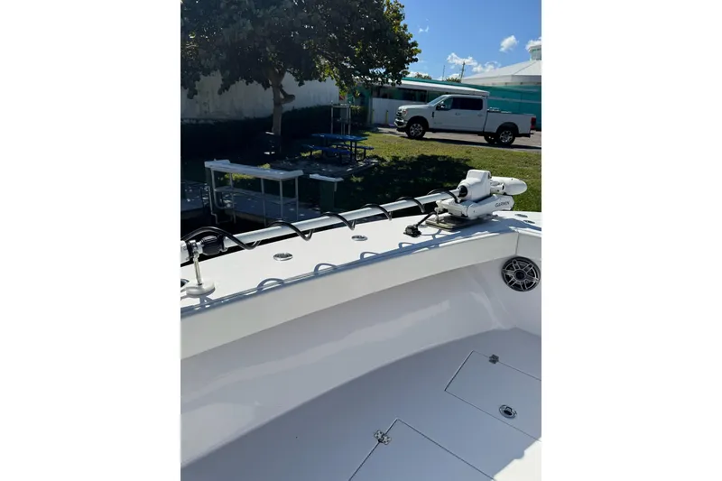 Slide: The Image of 2007 Conch 27 boat with trolling motor, docked near a parking area. - 8