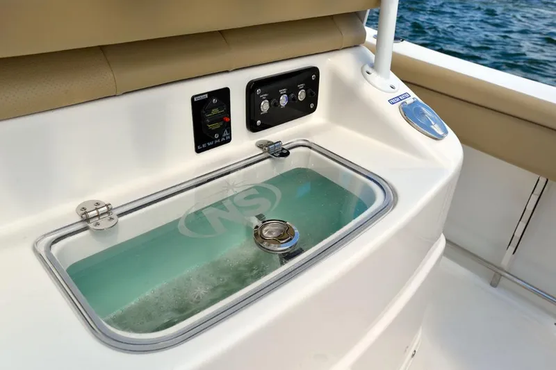 Slide: The Image of Manufacturer Provided Image: Livewell and control panel on a 2020 NauticStar 25 XS Offshore boat. - 17